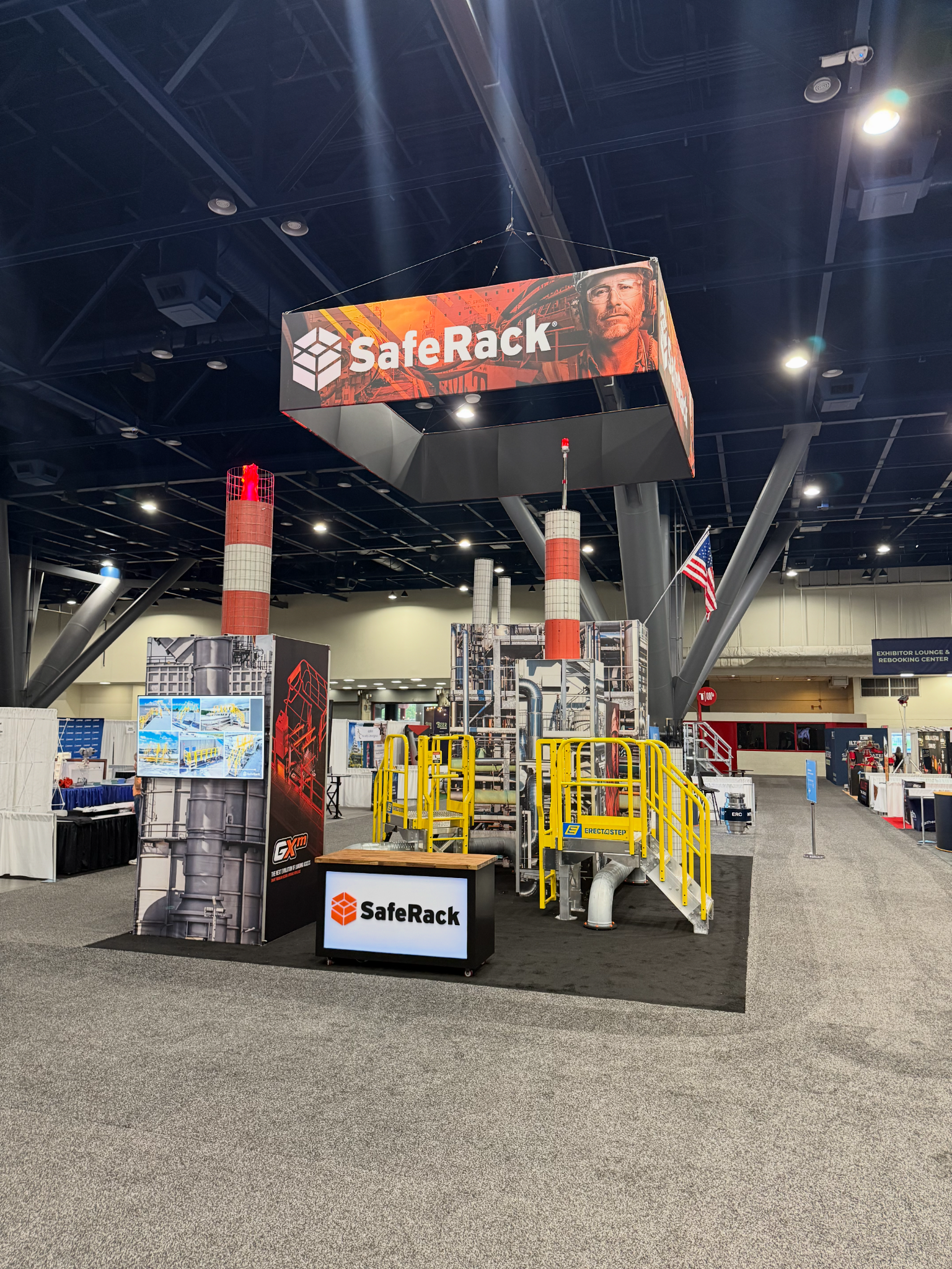 SafeRack trade show exhibit featuring branded overhead signage and industrial access equipment